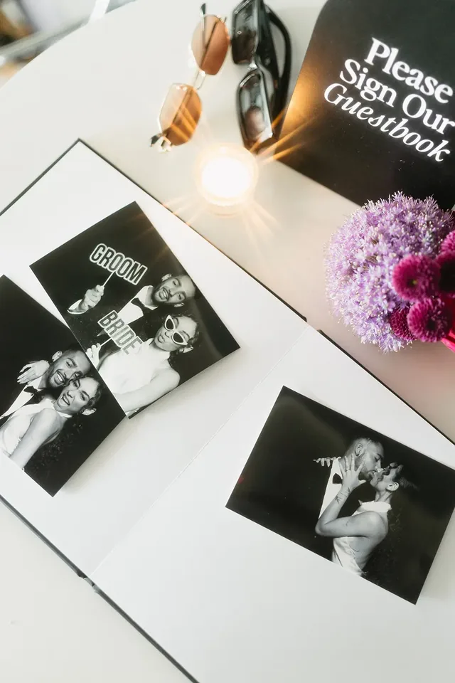 Keepsake album laid open with printed photos tucked inside